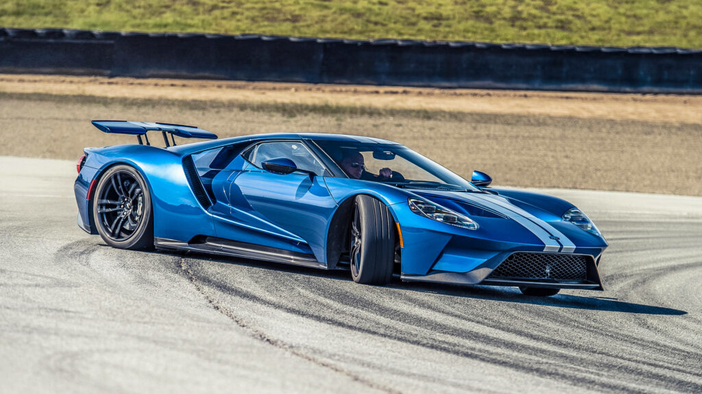 Cobalt blue Ford GT racing on track with sleek aerodynamic design high performance car wallpaper