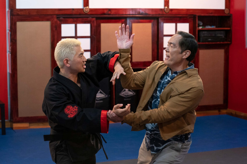 Two Men Train in Cobra Kai Style – Martial Arts Dojo Wallpaper