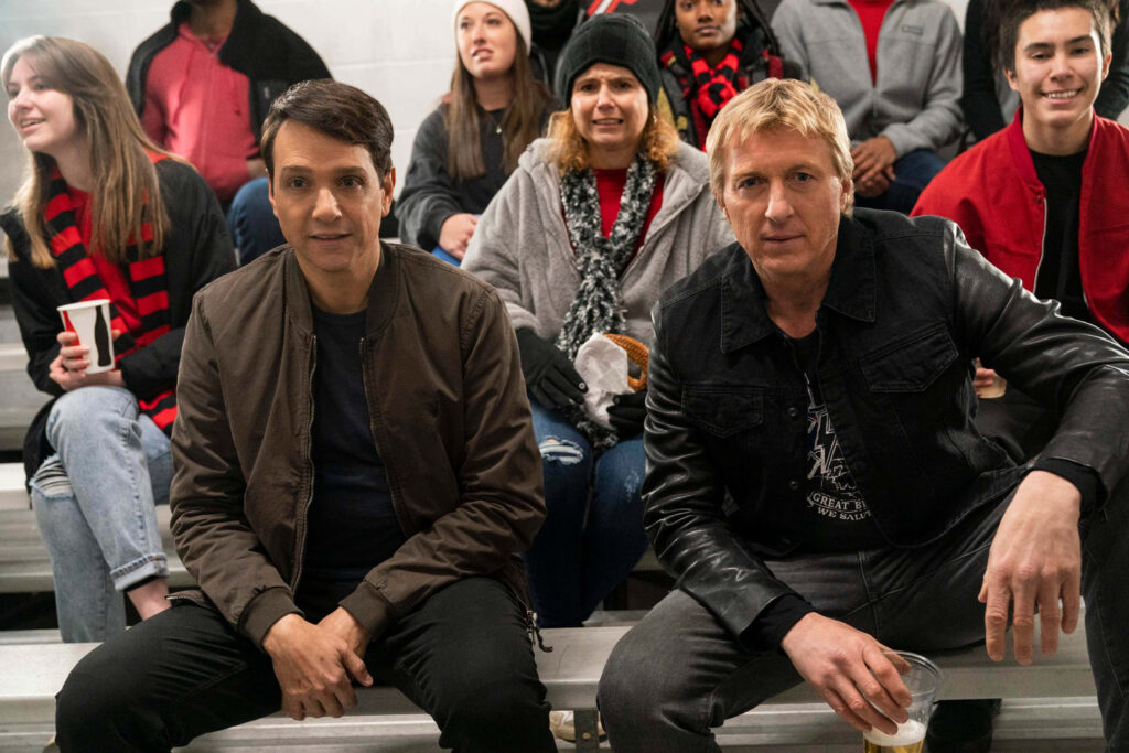 Cobra Kai Characters Gather: Intense Camaraderie Wallpaper Background