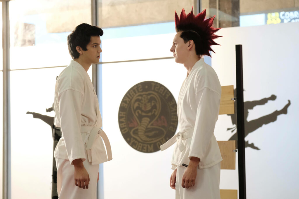 Cobra Kai Wallpaper: Miguel & Hawk Face Off in Karate Dojo
