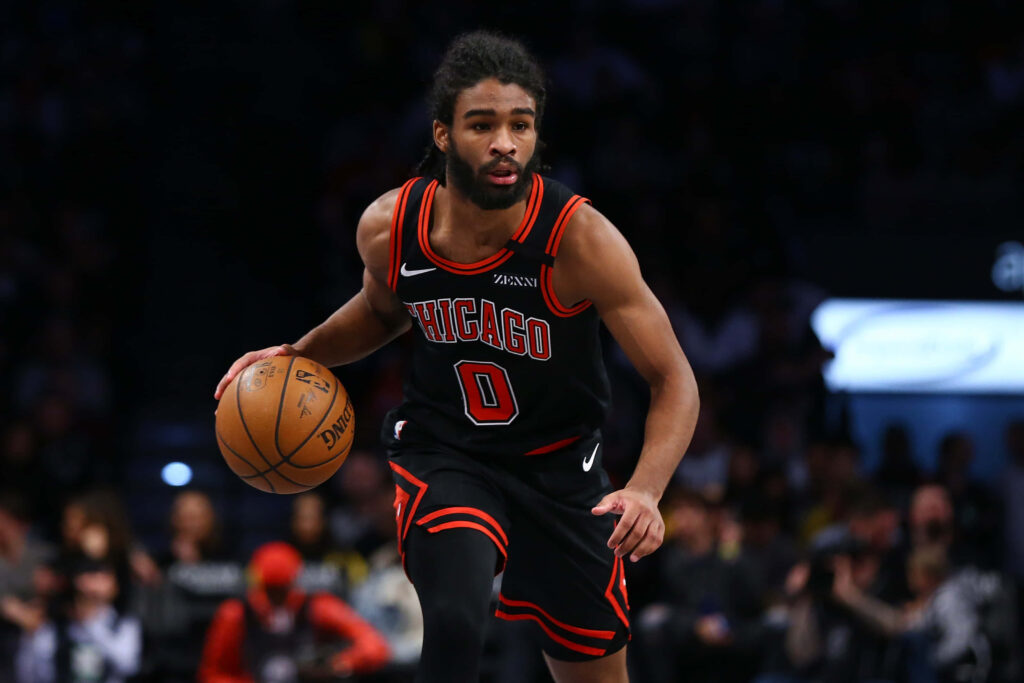 Coby White Chicago Bulls dribbling basketball in red black uniform intense focus game action Wallpaper