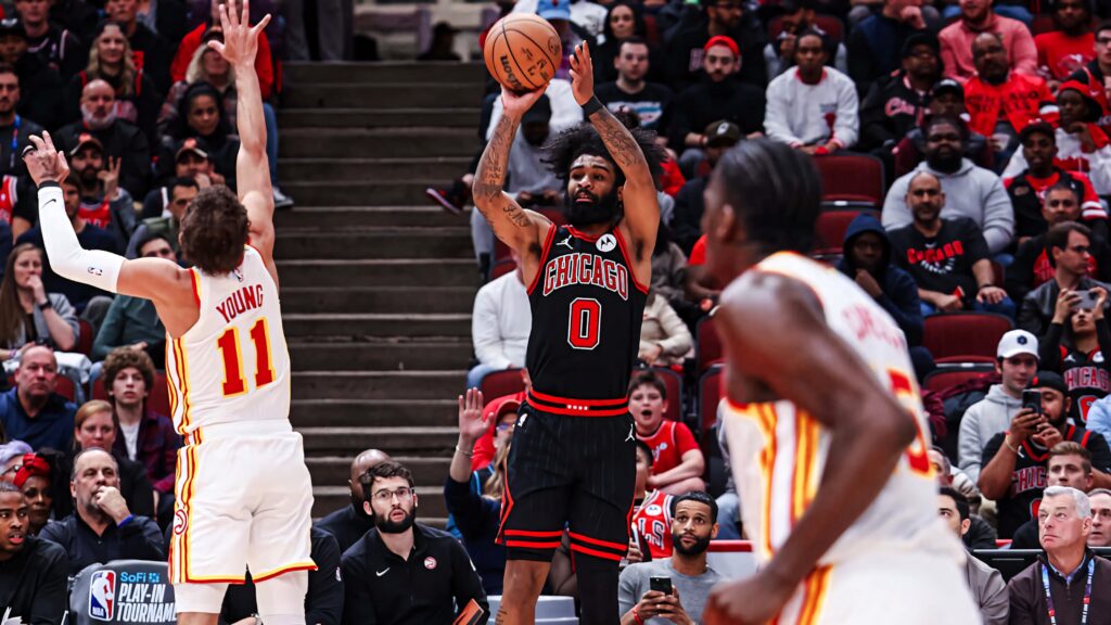 Coby White Chicago Bulls mid-air basketball shot intense game action packed arena background Wallpaper