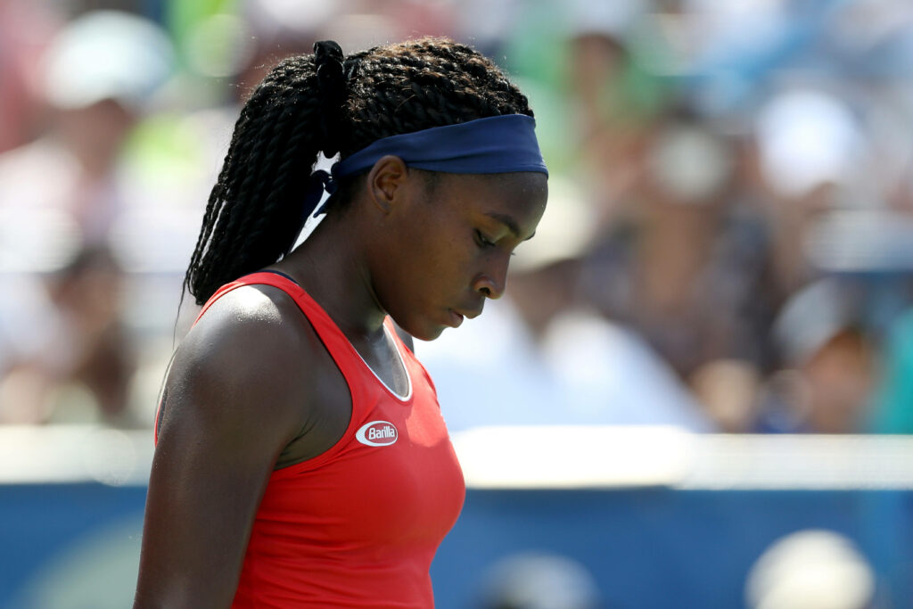 Coco Gauff focused in red tank top and headband athletic tennis player dynamic energy wallpaper