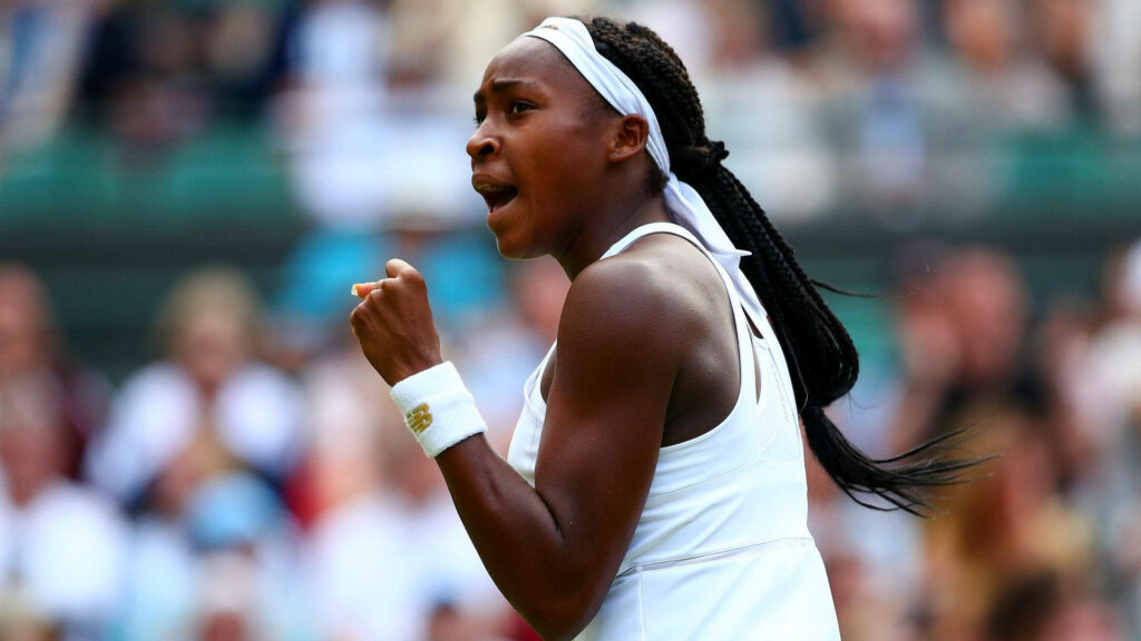 Coco Gauff celebrating on tennis court with raised fist showcasing focus and athleticism wallpaper