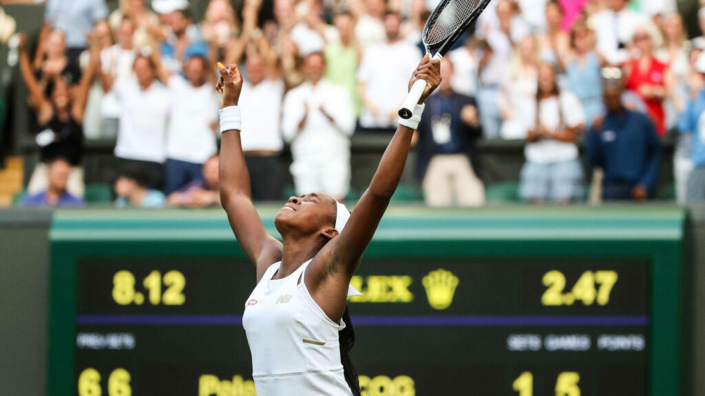 Coco Gauff celebrates tennis victory with raised arms in vibrant green white stadium crowd wallpaper