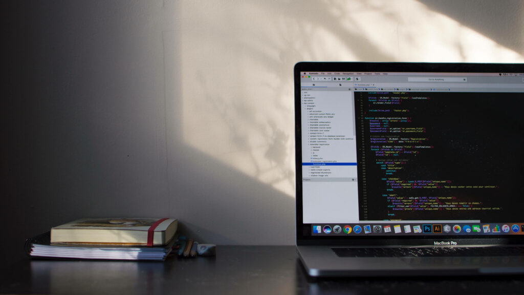 A Captivating Snapshot: Programming Software on a 4k Laptop, with Books as a Scenic Backdrop Wallpaper
