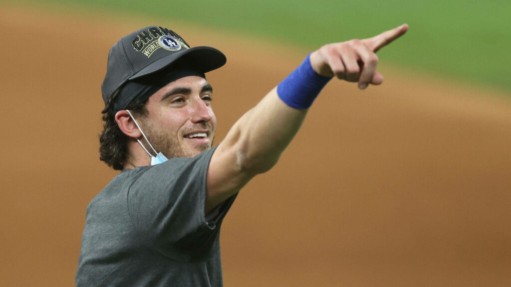 Cody Bellinger celebrating on baseball field smiling pointing wearing team cap and athletic gear Wallpaper