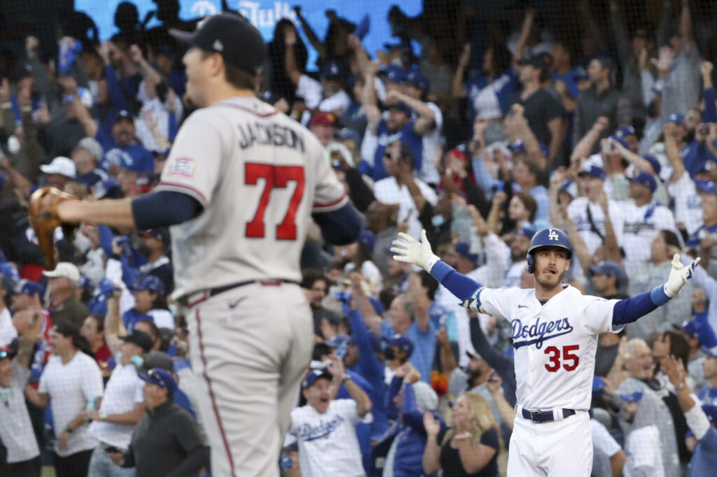 Cody Bellinger Dodgers number 35 celebrates victory on field with cheering blue stadium crowd Wallpaper