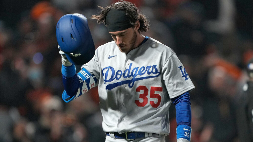 Cody Bellinger Dodgers player standing somber holding helmet in nighttime stadium lighting wallpaper