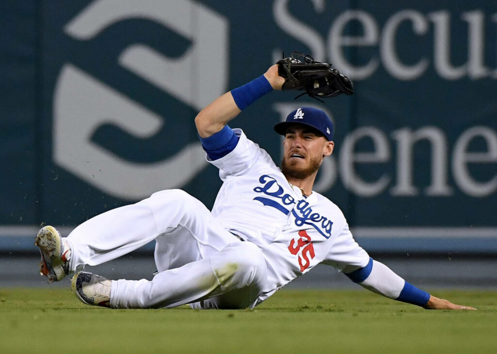 Cody Bellinger sliding catch in Dodgers uniform action baseball wallpaper vibrant green field