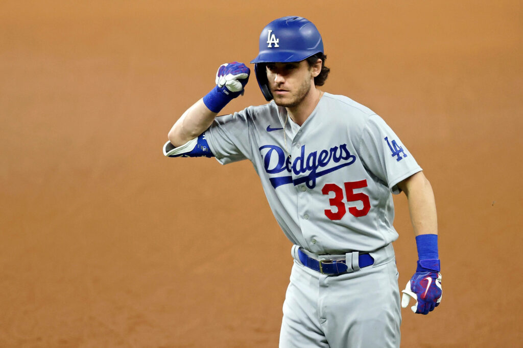 Cody Bellinger Los Angeles Dodgers in gray blue uniform with helmet and glove on baseball field Wallpaper