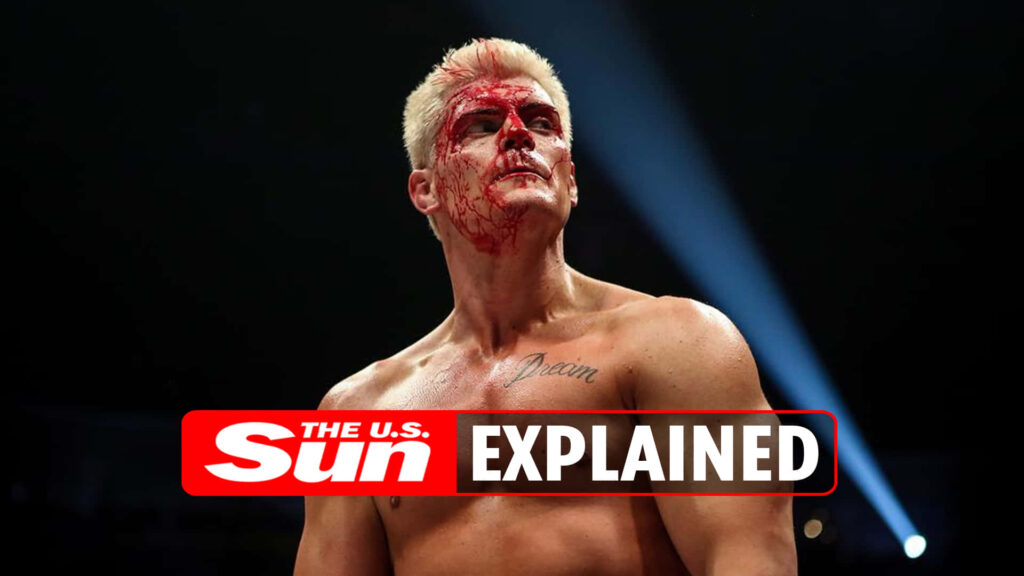 Cody Rhodes bloodied face spotlighted in gritty wrestling scene showing resilience and intensity Wallpaper