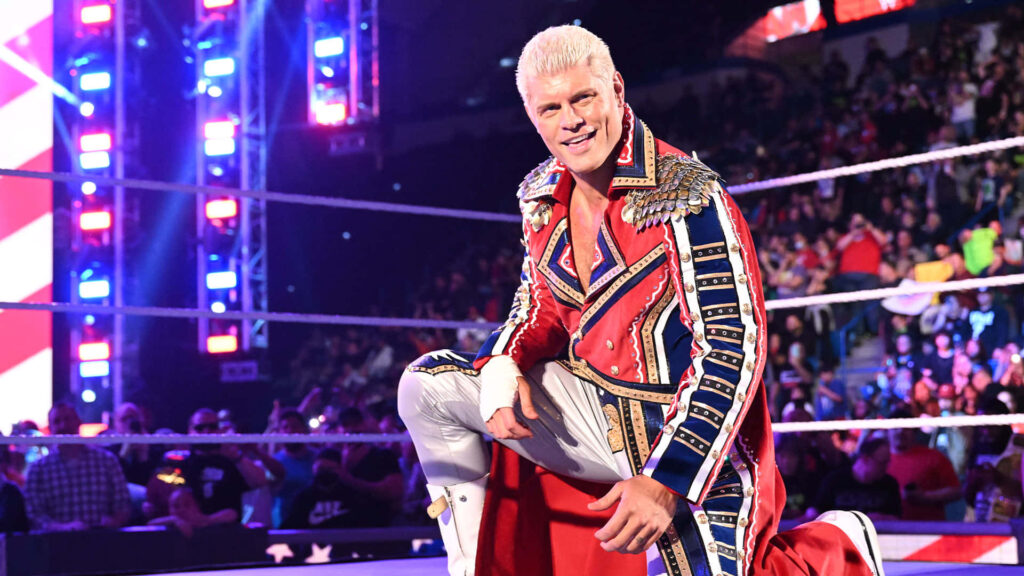 Cody Rhodes WWE ring entrance in red white blue robe with vibrant arena lights and crowd energy Wallpaper