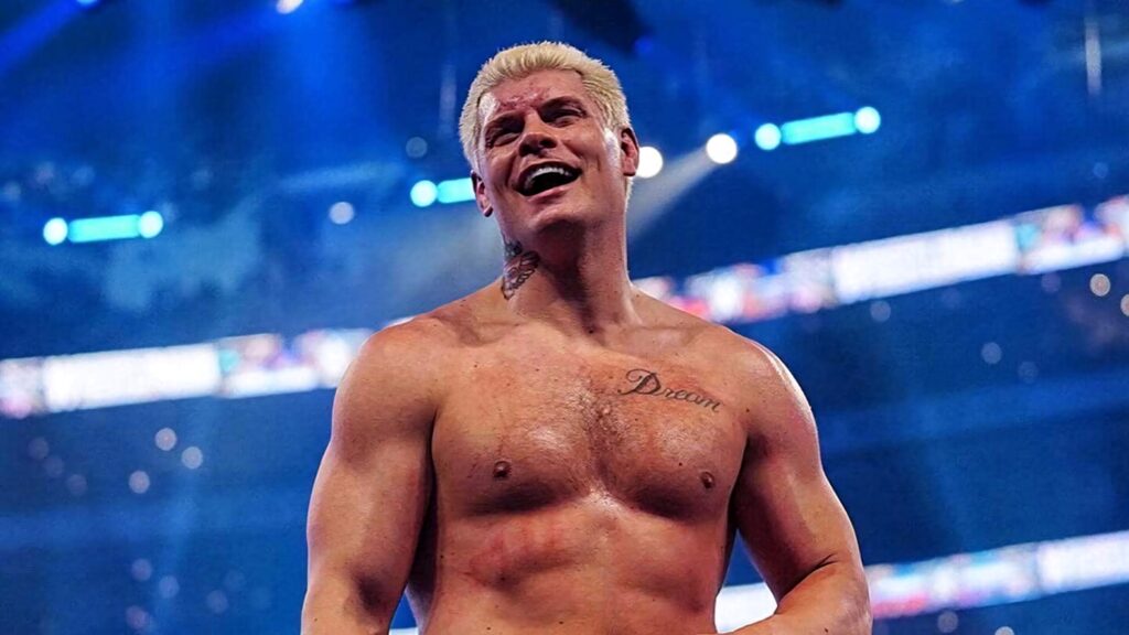 Cody Rhodes topless in WWE arena showing athletic physique under bright blue stage lights wallpaper