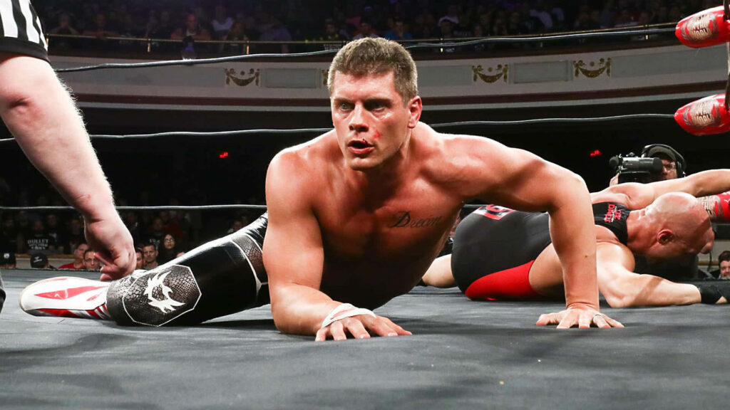 Cody Rhodes wrestling action wallpaper intense focus packed arena dramatic lighting background