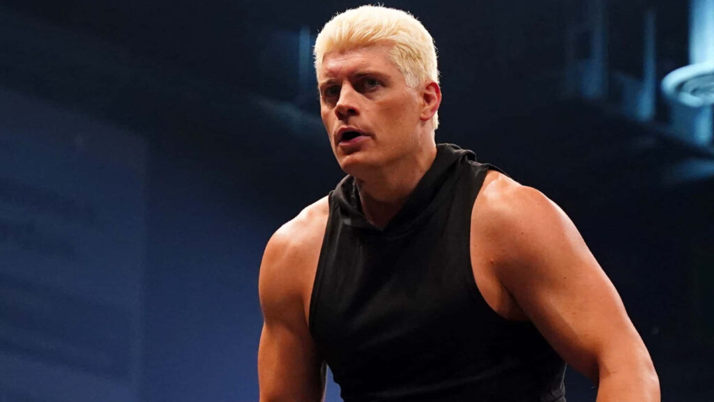 Cody Rhodes in black wrestling suit in dim arena showing focused intense powerful wrestler pose Wallpaper
