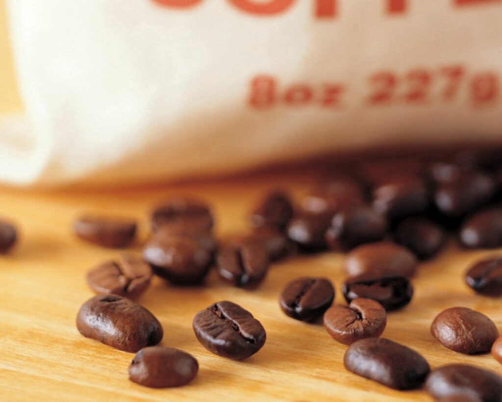 Stunning Coffee Beans on Wood: Perfect Wallpaper Background