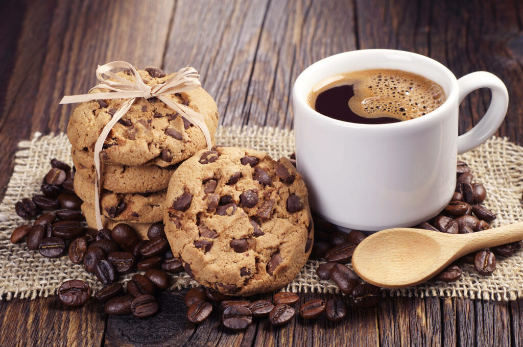 Indulging in Delights: Tempting Cookies and Bold Coffee in a Rustic Setting Wallpaper