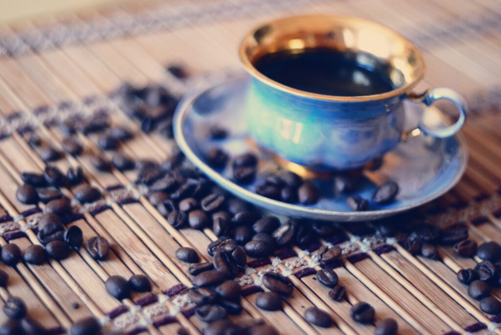 Warm Coffee Cup Close-Up with Golden Rim & Beans - Rustic Wallpaper