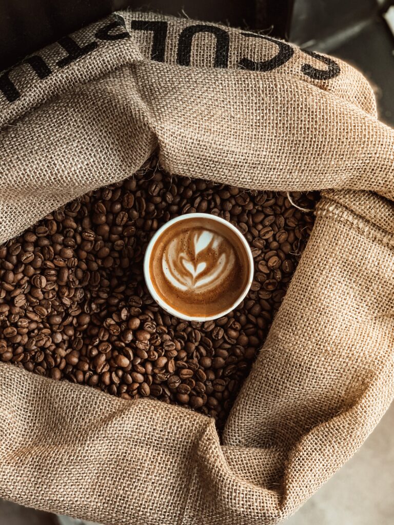 Latte Art Coffee on Roasted Beans: Rustic Wallpaper Background