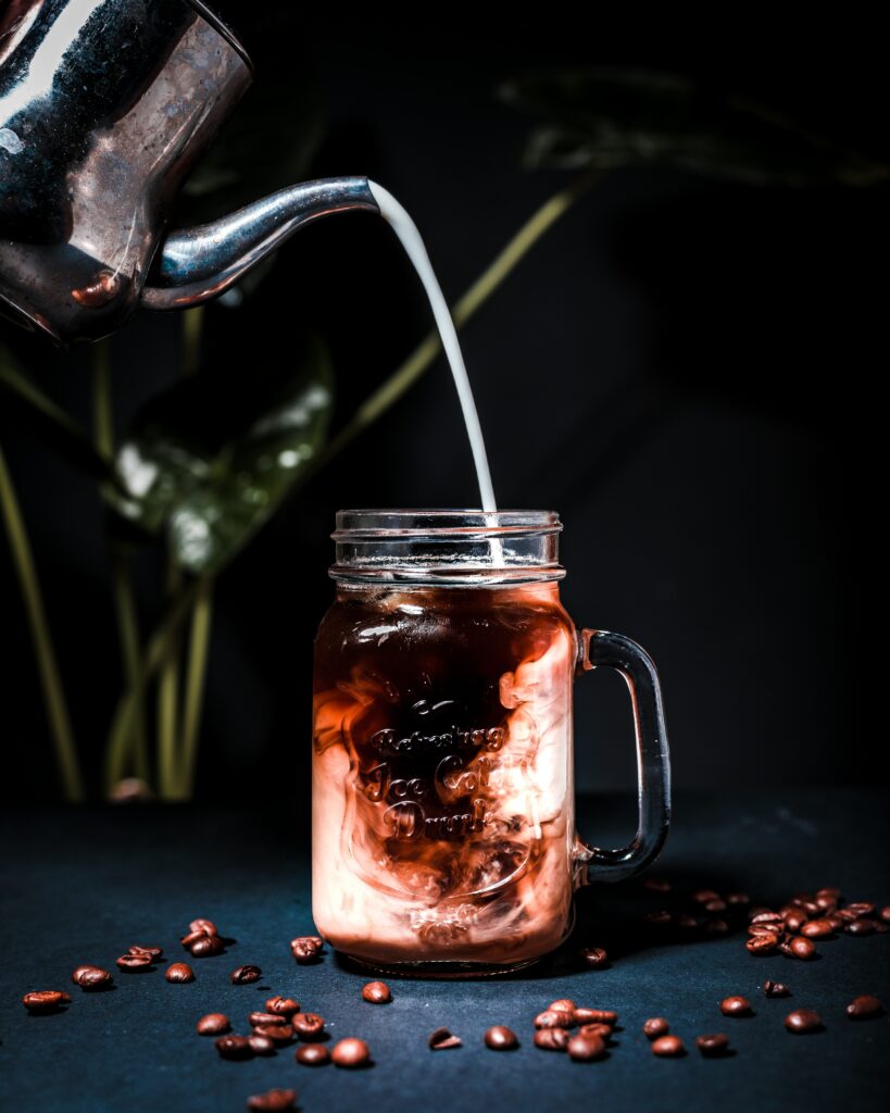Rich Coffee Wallpaper: Glass Mug, Milk, and Coffee Beans in Dark Mood