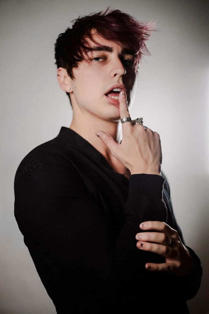 Colby Brock dramatic portrait moody lighting silver rings dark top confident gaze wallpaper