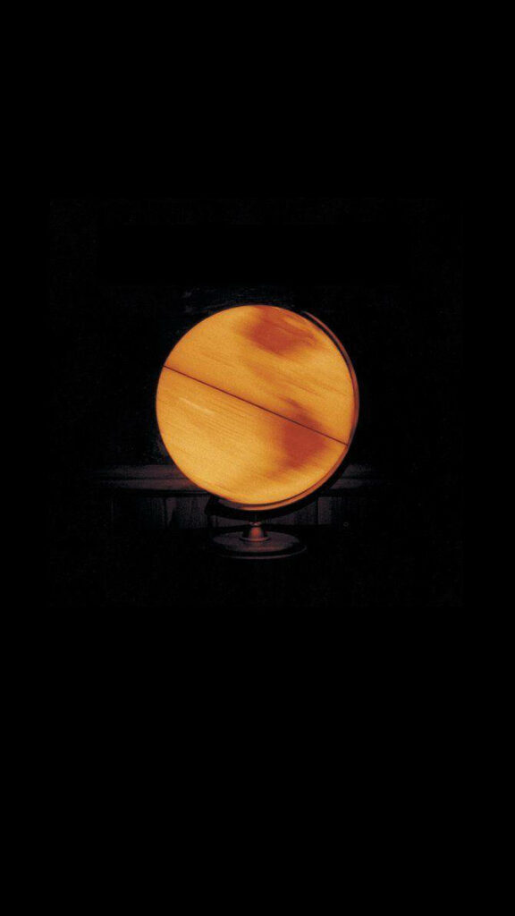 Coldplay Parachutes album glowing yellow globe on black minimalist atmospheric wallpaper background