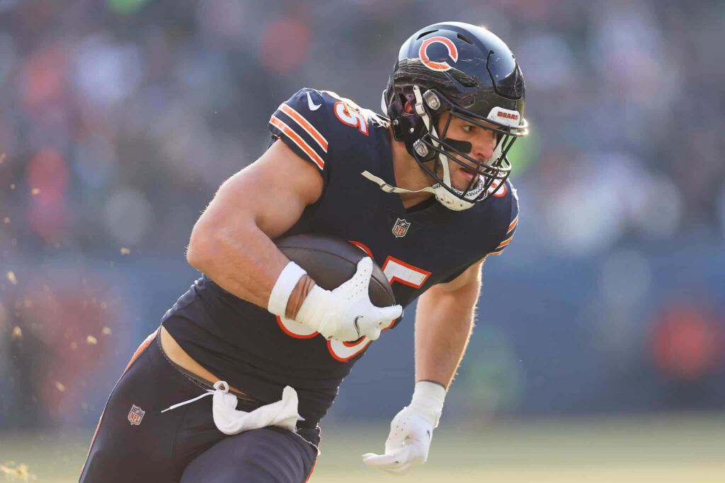 Cole Kmet Chicago Bears tight end in action wearing navy blue uniform clutching football wallpaper