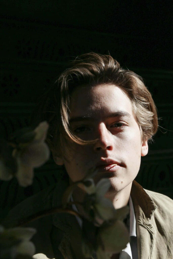 Cole Sprouse portrait wallpaper with dramatic lighting soft shadows and natural artistic depth background