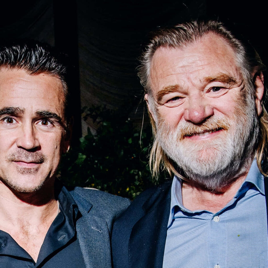 Colin Farrell and Brendan Gleeson close-up portrait in dark suits on soft light background wallpaper