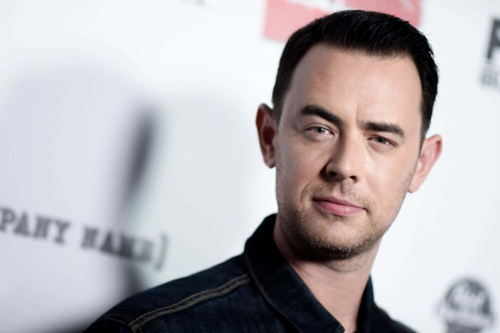 Colin Hanks portrait in denim jacket with calm expression and soft blurred event background wallpaper