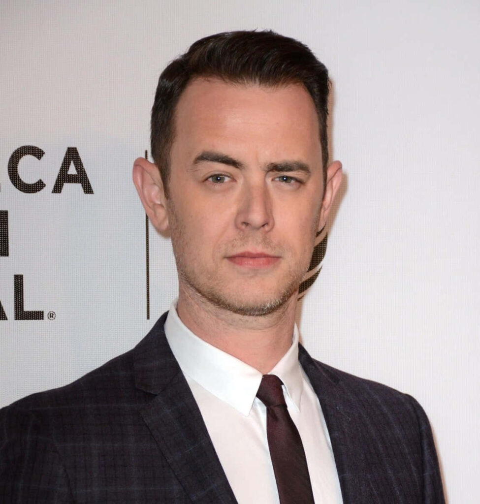 Colin Hanks in classic formal suit with soft lighting on light background elegant professional wallpaper