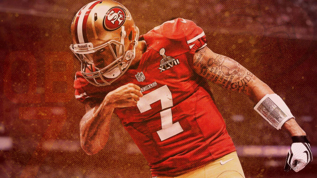 Colin Kaepernick in red 49ers jersey striking powerful pose with bold tattoos football wallpaper