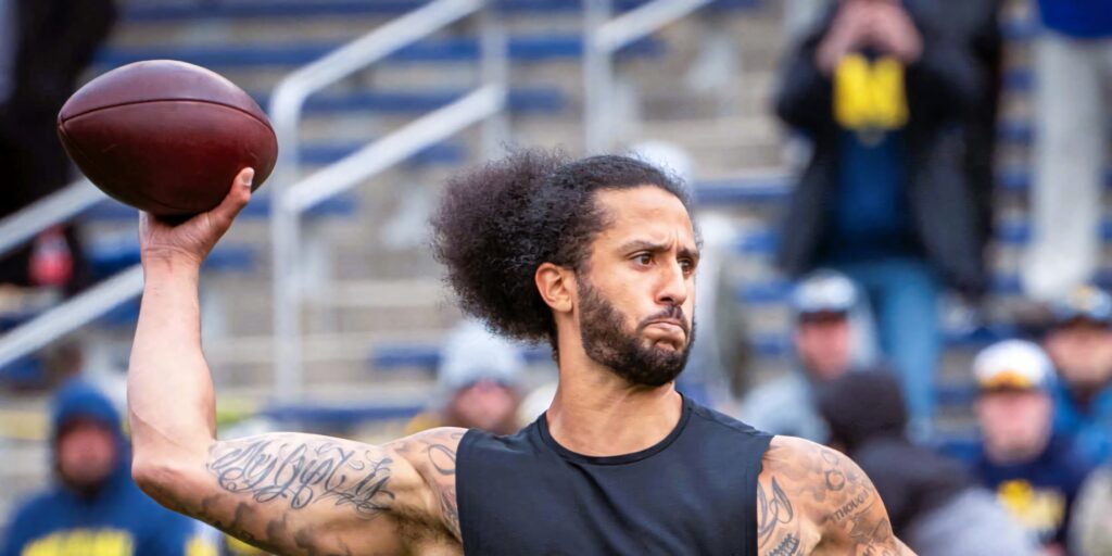 Colin Kaepernick mid-throw vibrant wallpaper showcasing athleticism focus and signature style