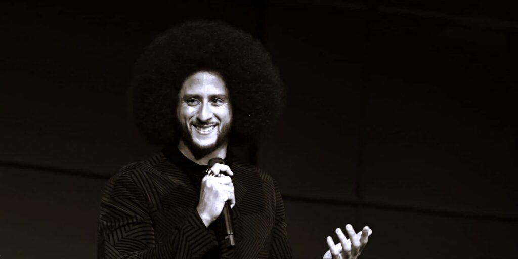 Colin Kaepernick monochrome wallpaper smiling with microphone iconic afro bold inspirational background