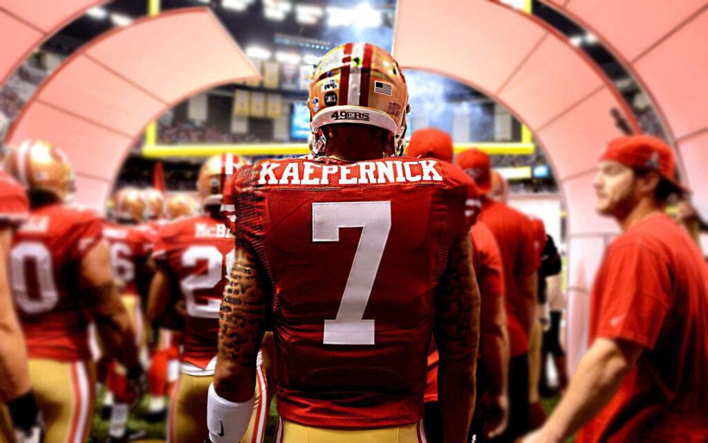 Colin Kaepernick in number 7 49ers uniform leading team on field vibrant game day wallpaper background