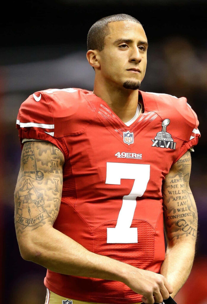Colin Kaepernick in red 49ers jersey number 7 showing focus and athleticism wallpaper background