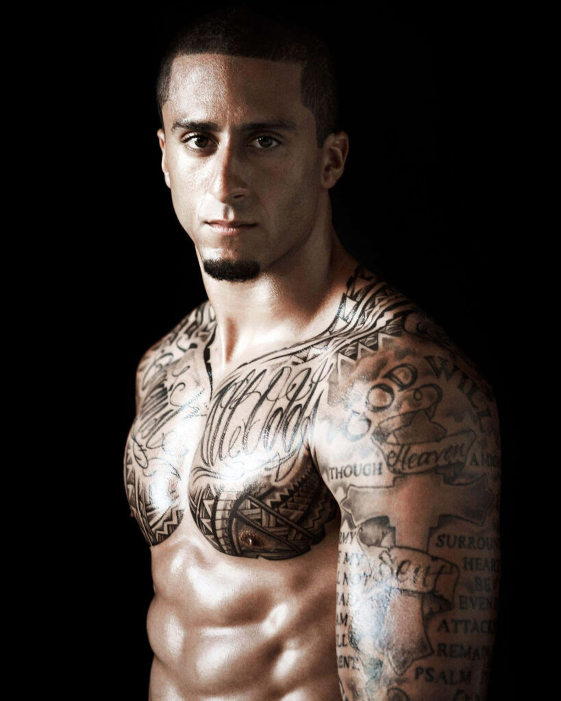 Colin Kaepernick portrait with dramatic lighting showcasing tattoos and intense expression wallpaper