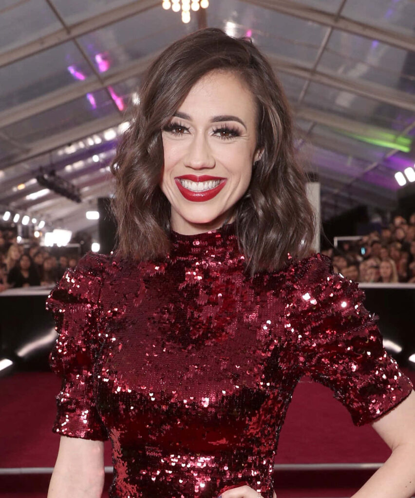 Colleen Ballinger in sparkling deep red sequin dress at glamorous event with dramatic lighting Wallpaper