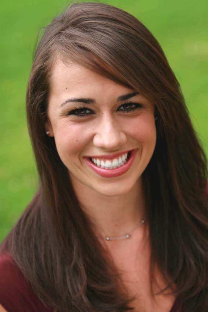 Colleen Ballinger vibrant portrait smiling with glossy hair and expressive eyes in green background Wallpaper