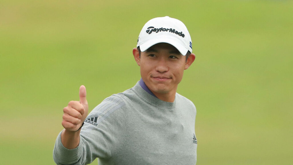 Collin Morikawa confident thumbs up on golf course wearing grey Adidas sweater and TaylorMade cap Wallpaper