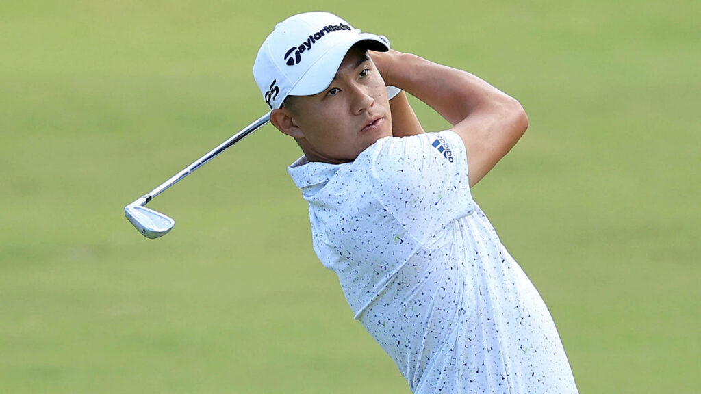 Collin Morikawa hitting golf shot on green course wearing white shirt and cap professional golfer Wallpaper