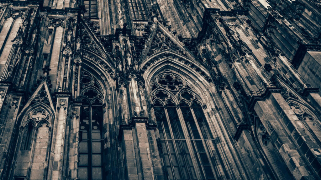 Cologne Cathedral exterior Gothic arches intricate stonework towering windows historic grandeur wallpaper