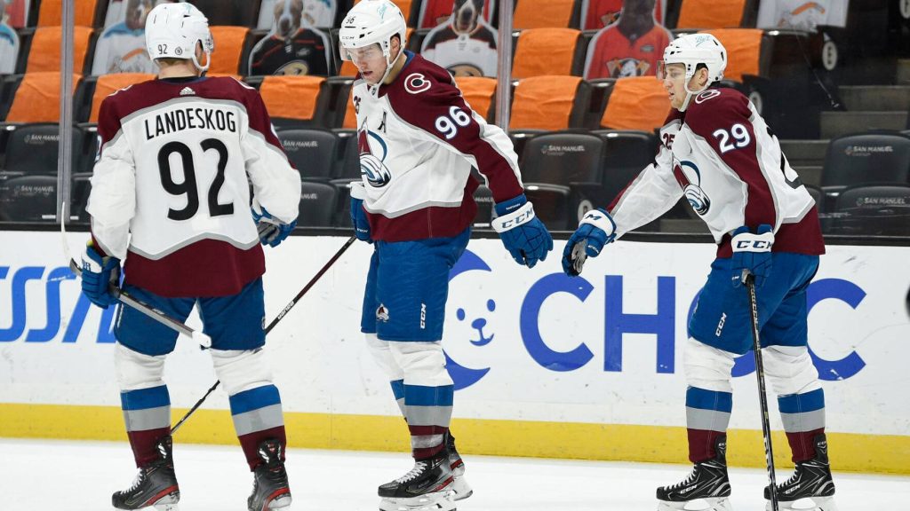 Colorado Avalanche stars Landeskog Rantanen MacKinnon in white away jerseys ice hockey wallpaper