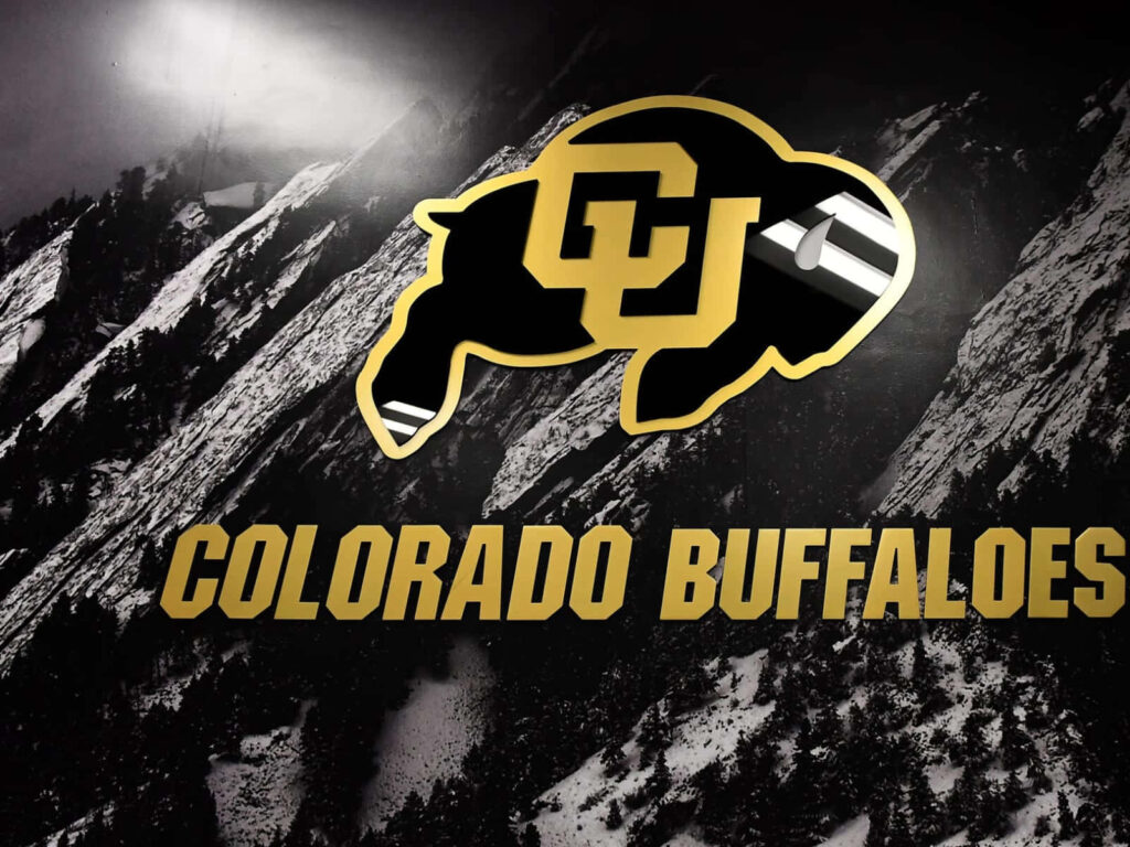 Colorado Buffaloes logo in black gold over grayscale mountains showcasing team spirit wallpaper