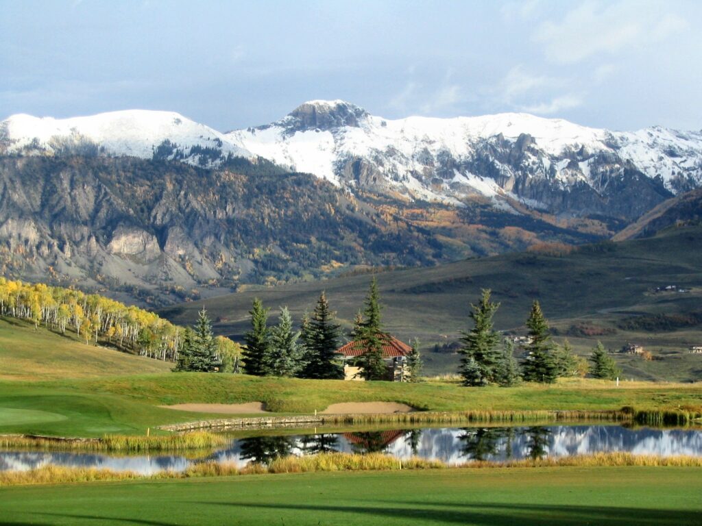 Colorado mountain landscape wallpaper with snow peaks autumn trees and reflective clear lake