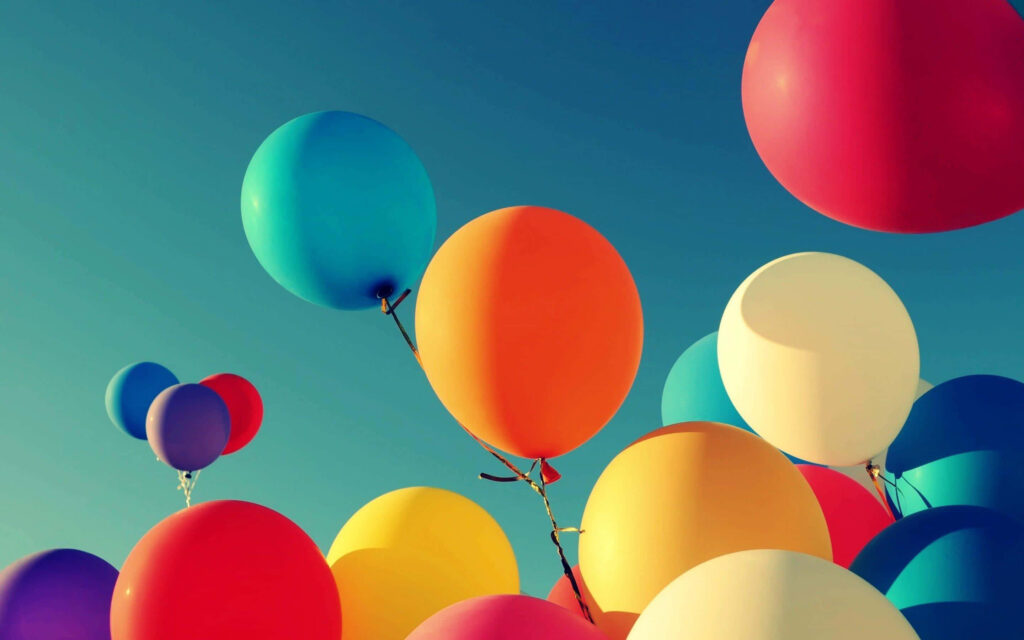 Colorful Balloons Against Blue Sky: Cheerful Festive Background Wallpaper