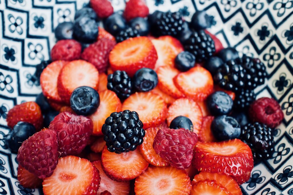 Colorful Berry Medley in Bowl: Vibrant Blackberry, Raspberry, Strawberry Wallpaper