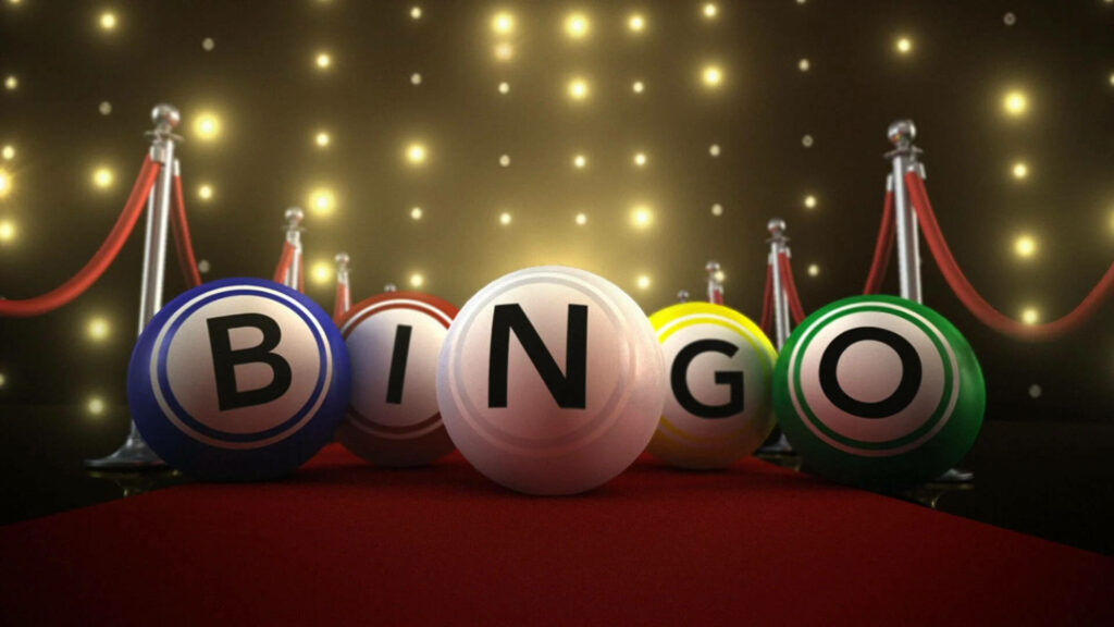 Colorful bingo balls spelling BINGO on red carpet with rope barriers and festive lights background Wallpaper