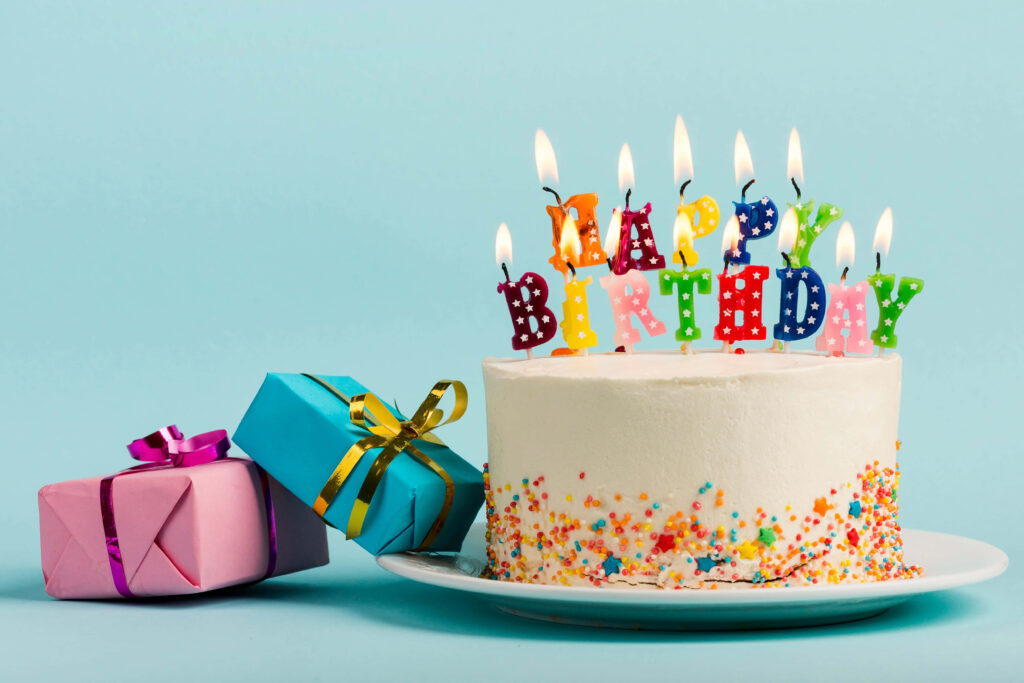 Colorful Birthday Cake Wallpaper with Candles & Festive Presents